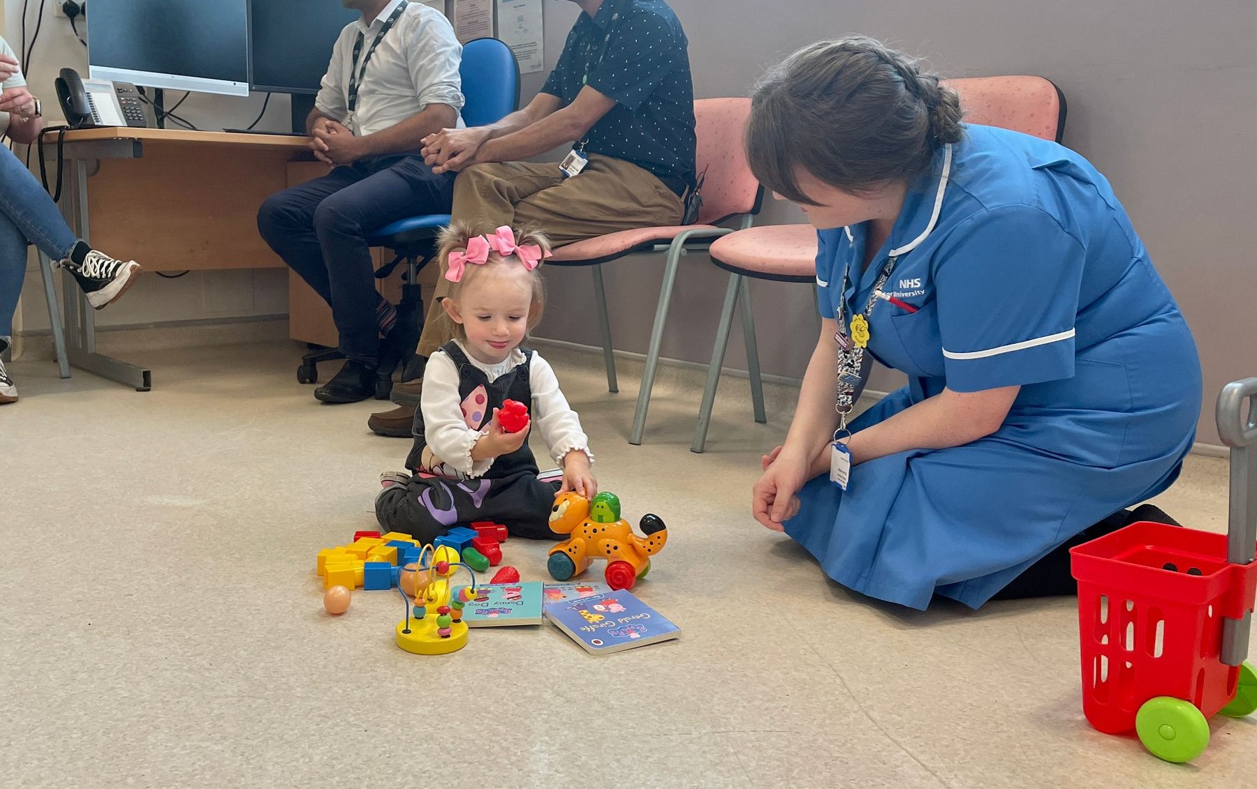 Photo of Teddi Shaw playing with a nurse