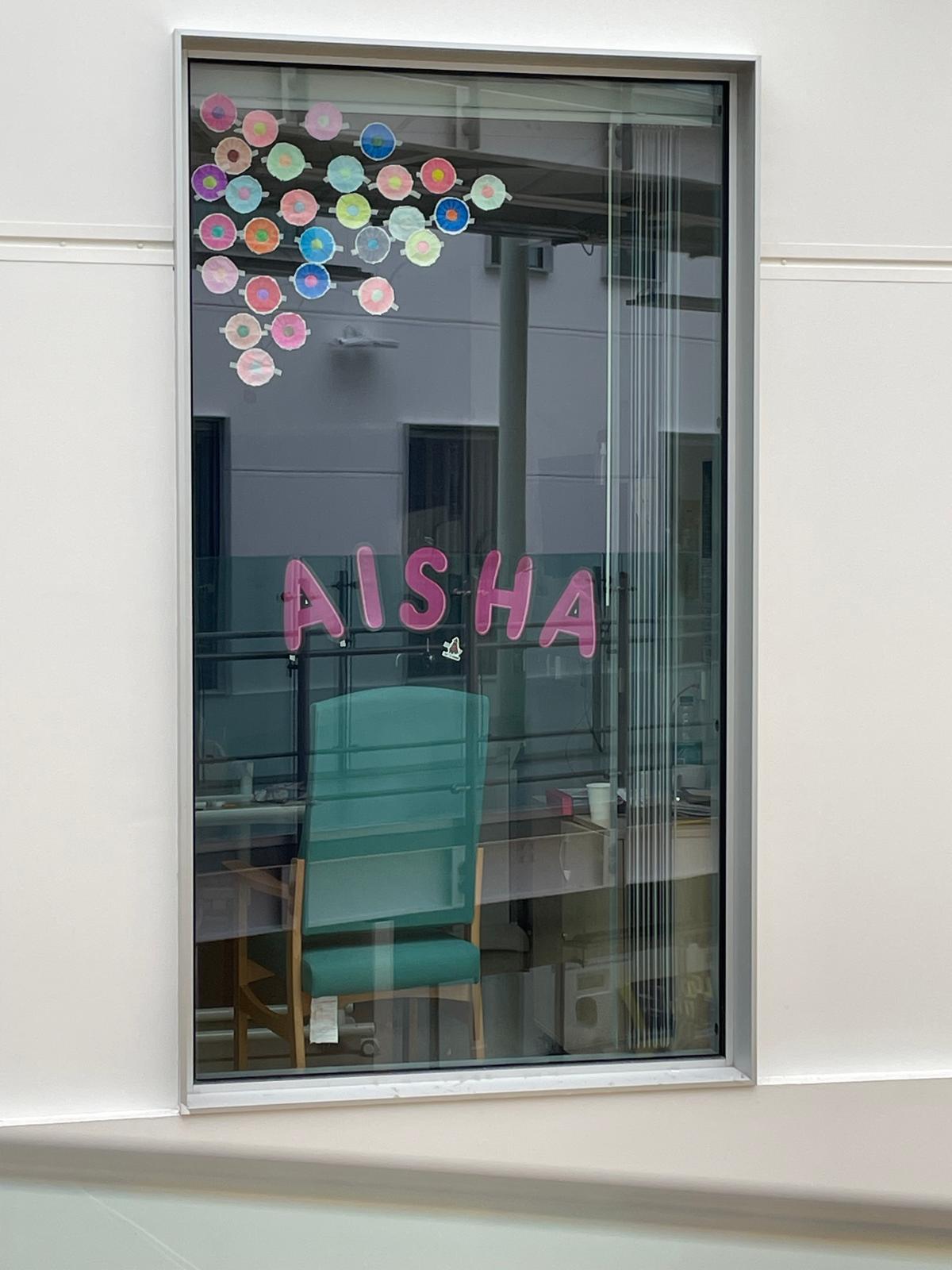 Window with Aisha written across it.