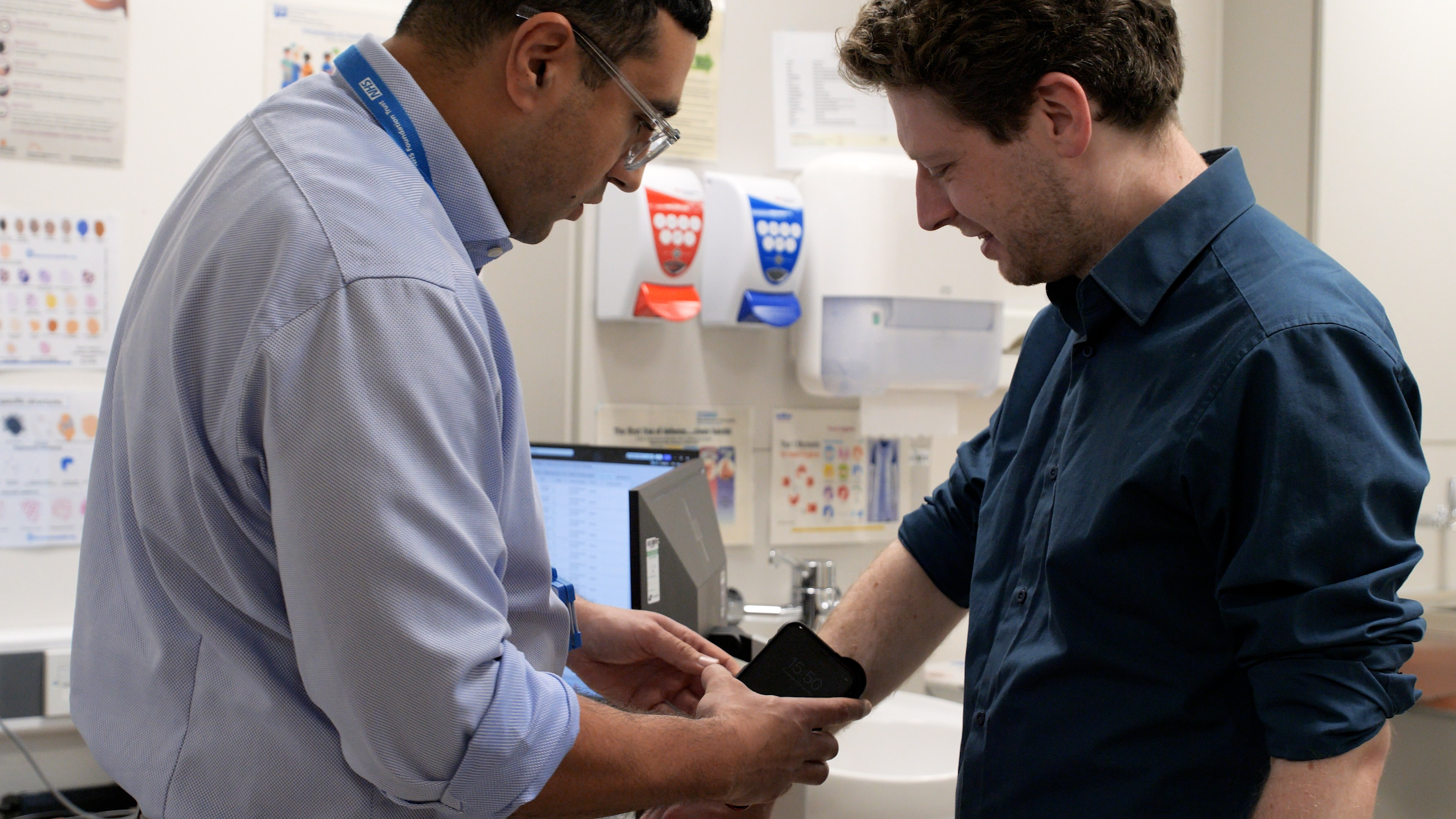 Doctor holding dermatology device against arm of Connor Rand MP